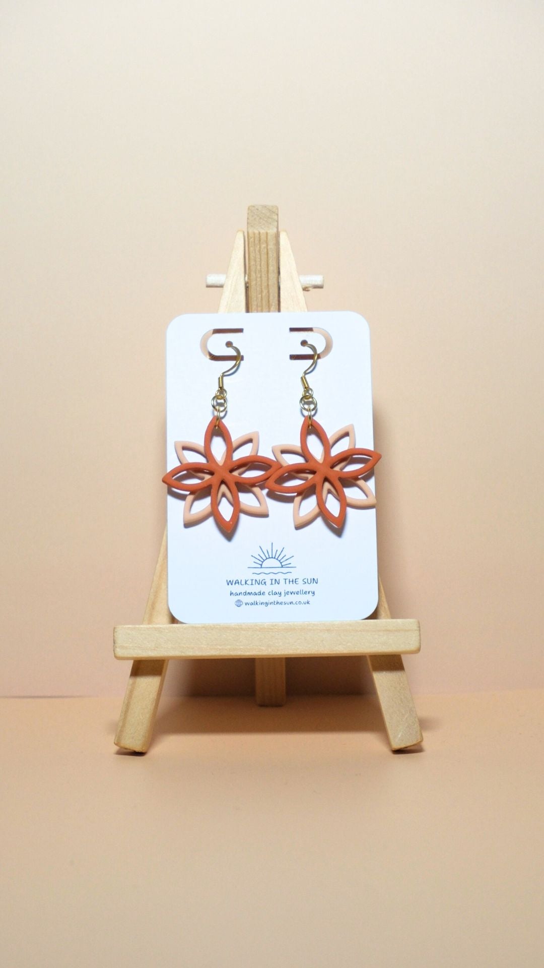 Handmade floral overlap polymer clay earrings in sunny orange and sandy beige