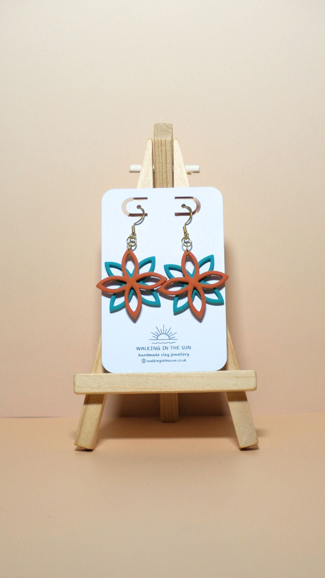 Handmade floral overlap polymer clay earrings in sunny orange and sea blue
